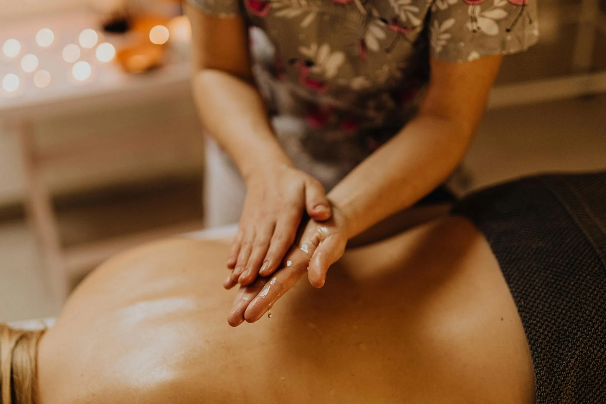 Ayurvedic Abhyanga Massage - Practitioner applying warm herbal oils with flowing strokes
