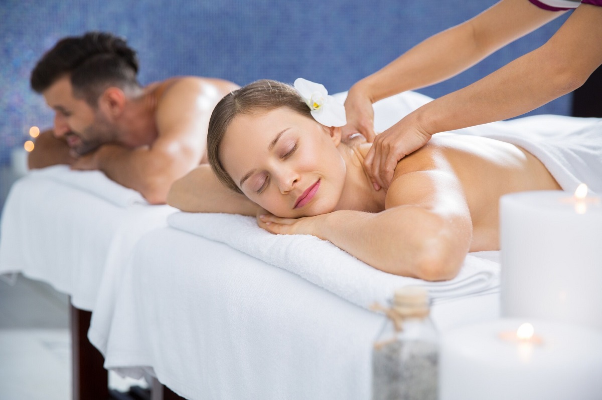 Balinese Massage - Spa setting with practitioner applying aromatic oils using long, flowing strokes